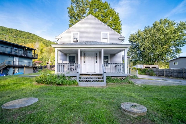 view of front facade with covered porch and a front yard