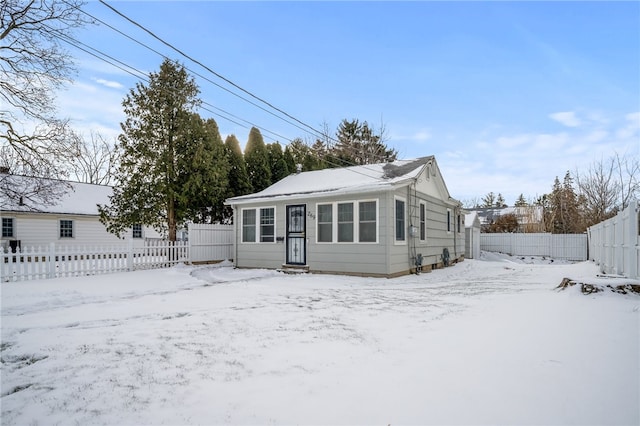 view of snow covered back of property