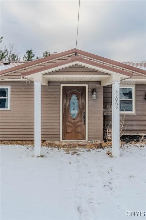 view of snow covered property entrance