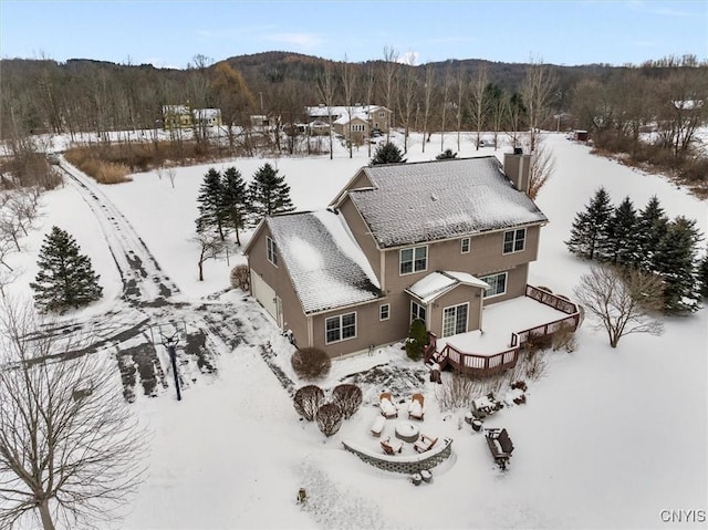 snowy aerial view featuring a mountain view