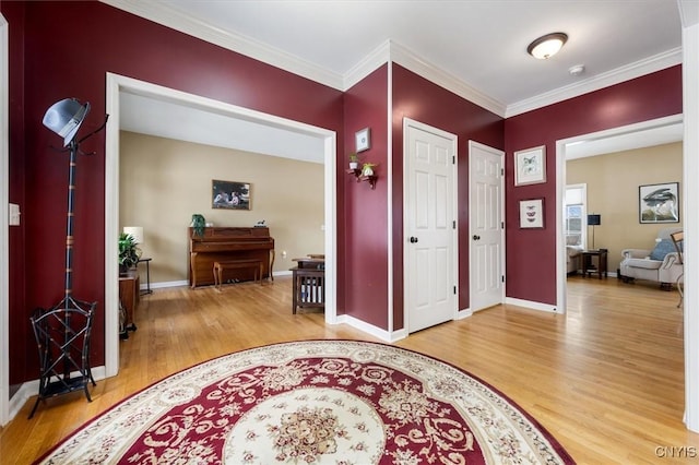 entrance foyer with hardwood / wood-style floors and crown molding