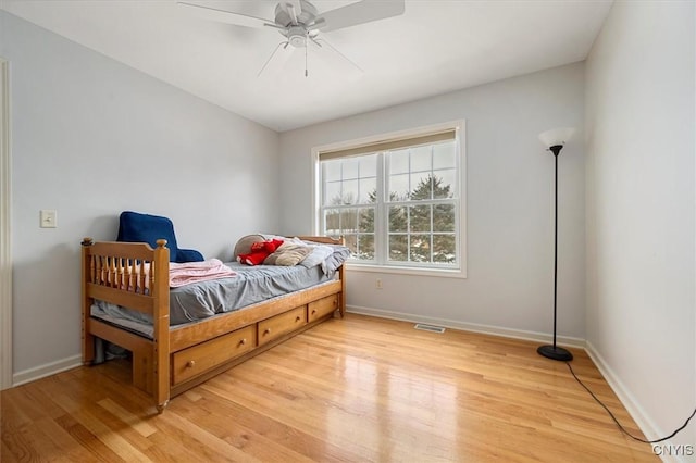 bedroom with ceiling fan and light hardwood / wood-style flooring