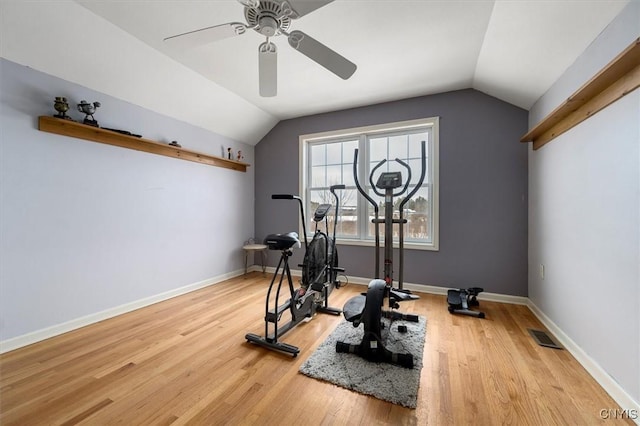 exercise room with ceiling fan, lofted ceiling, and light hardwood / wood-style flooring