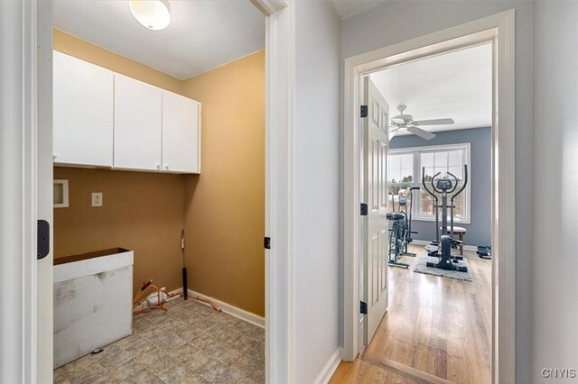 clothes washing area featuring light hardwood / wood-style flooring and ceiling fan