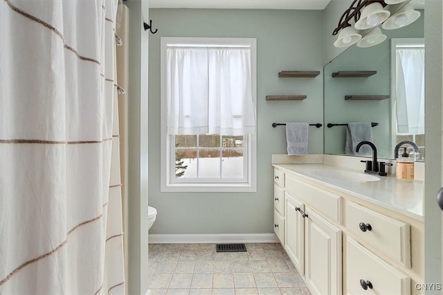 bathroom featuring vanity and toilet