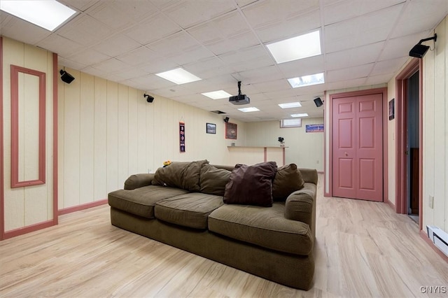 living room featuring a paneled ceiling and light hardwood / wood-style floors