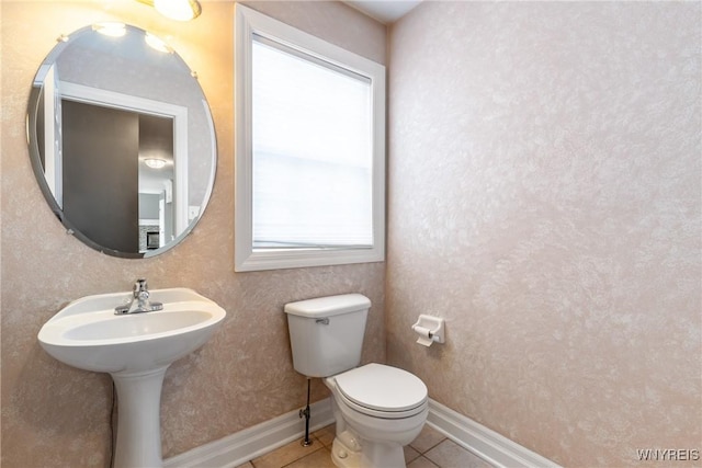 bathroom featuring tile patterned flooring and toilet