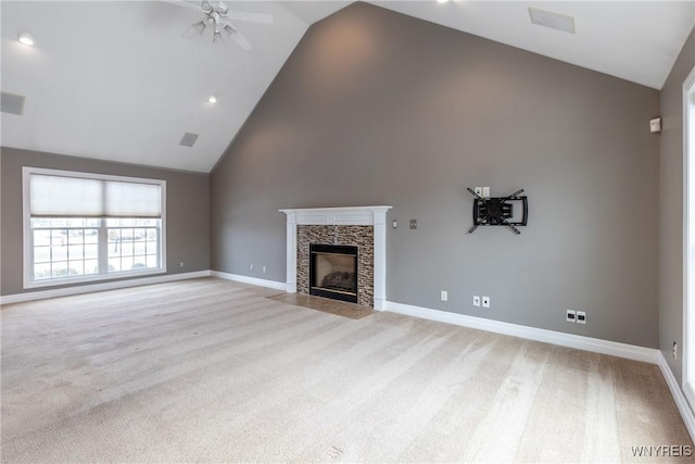 unfurnished living room featuring light carpet, ceiling fan, lofted ceiling, and a tiled fireplace