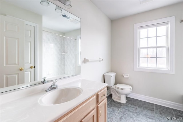 bathroom with vanity, toilet, and curtained shower