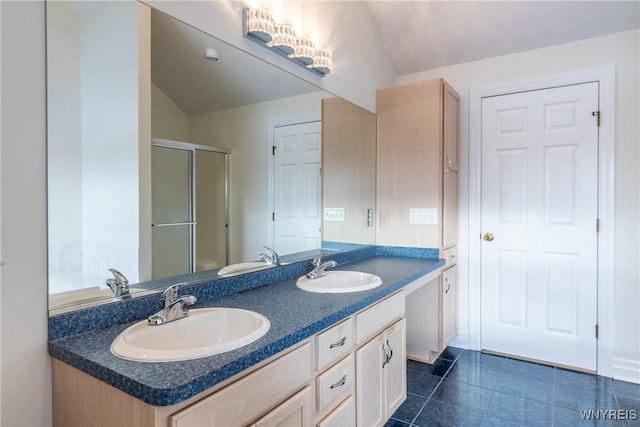 bathroom featuring tile patterned floors, vanity, lofted ceiling, and walk in shower