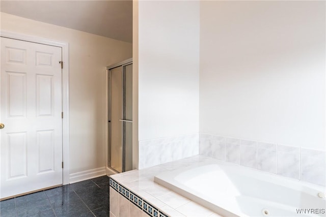 bathroom featuring separate shower and tub