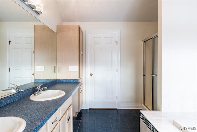 bathroom featuring a shower with door, vanity, and tile patterned flooring