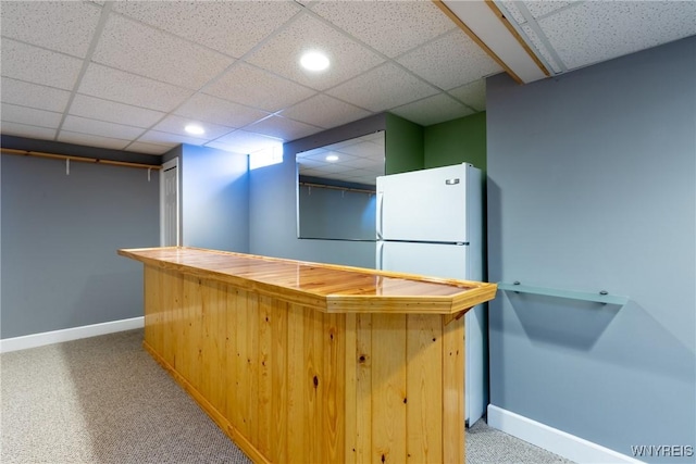 bar with carpet, a paneled ceiling, and white refrigerator