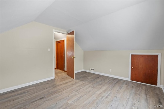 bonus room featuring hardwood / wood-style floors and lofted ceiling