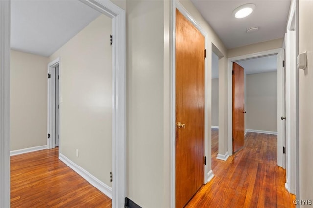 hall with hardwood / wood-style flooring