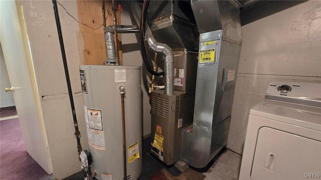 utilities with washer / clothes dryer, water heater, and heating unit