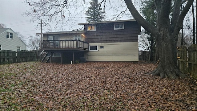 back of property with a wooden deck