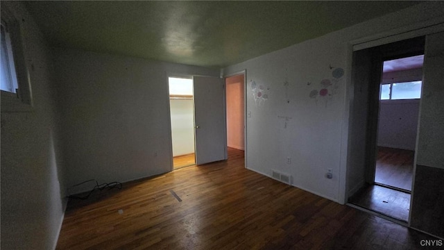 unfurnished bedroom with dark hardwood / wood-style flooring