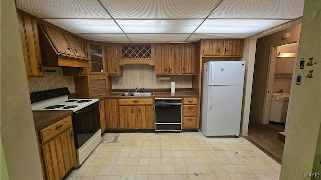 kitchen featuring premium range hood, a paneled ceiling, sink, and white appliances