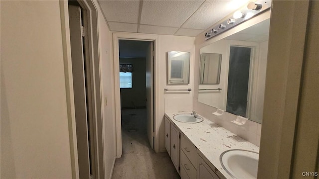 bathroom with vanity and a drop ceiling