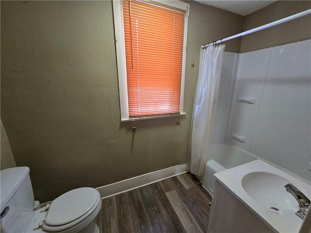 bathroom with wood-type flooring, shower / tub combo, and toilet