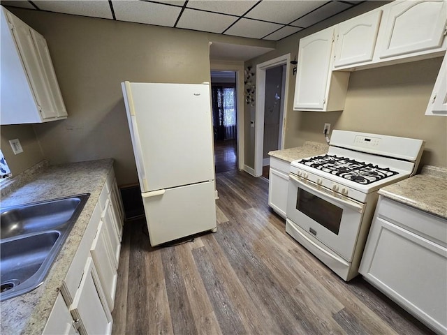 kitchen featuring a drop ceiling, white cabinetry, white appliances, and dark hardwood / wood-style floors