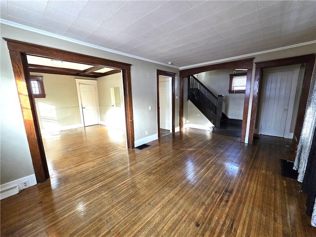 spare room with dark hardwood / wood-style floors and crown molding