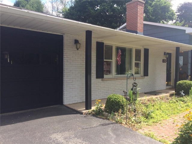 view of exterior entry with a garage