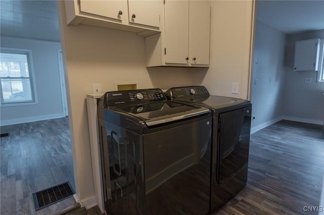 laundry room with dark hardwood / wood-style floors, cabinets, and independent washer and dryer