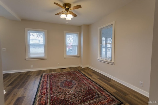 spare room featuring ceiling fan and dark hardwood / wood-style flooring