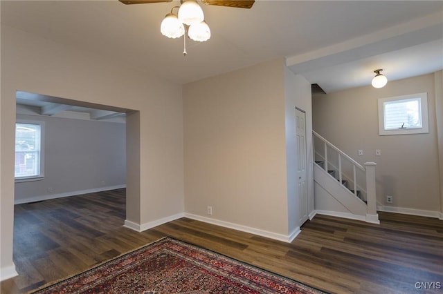 unfurnished room featuring ceiling fan and dark wood-type flooring