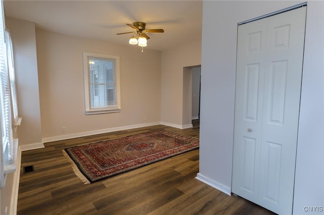 interior space featuring ceiling fan and dark hardwood / wood-style flooring