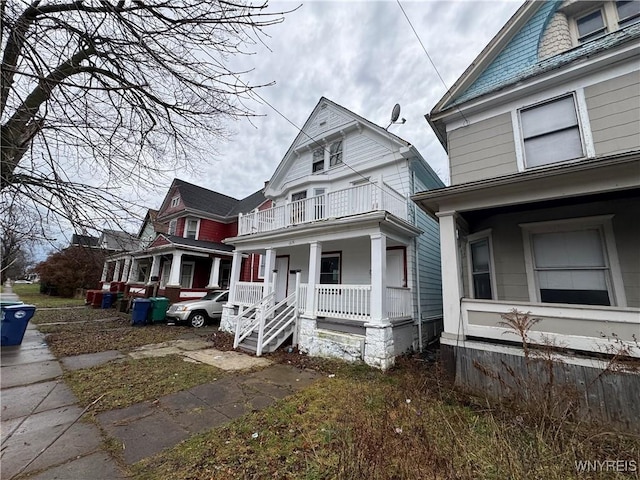 view of front of house featuring covered porch and a balcony