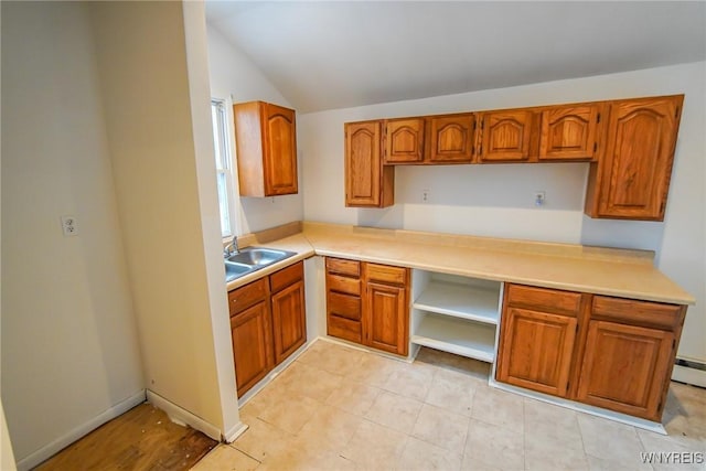 kitchen featuring lofted ceiling and sink