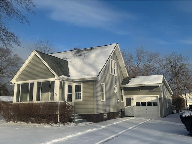 view of snowy exterior with a garage