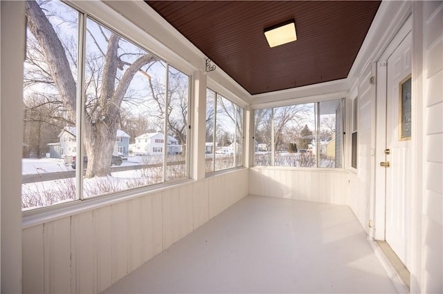 unfurnished sunroom with plenty of natural light and wood ceiling