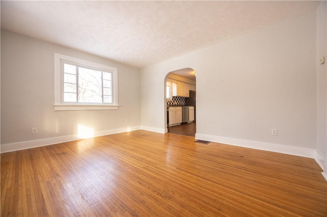 unfurnished living room with hardwood / wood-style flooring