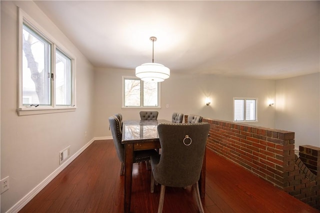 dining area featuring dark wood-type flooring