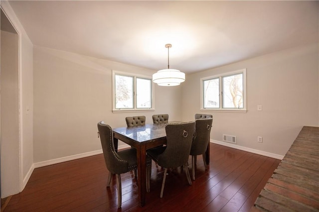 dining area with dark hardwood / wood-style flooring