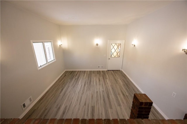 unfurnished room featuring hardwood / wood-style floors