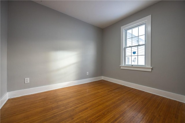 unfurnished room with hardwood / wood-style floors