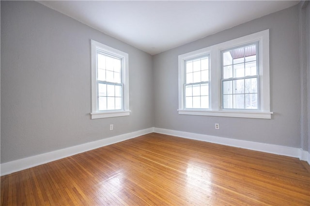 spare room with plenty of natural light and light wood-type flooring