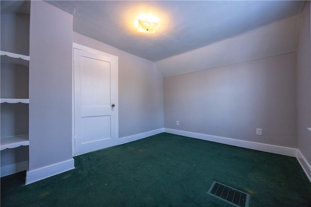 bonus room featuring dark colored carpet and lofted ceiling