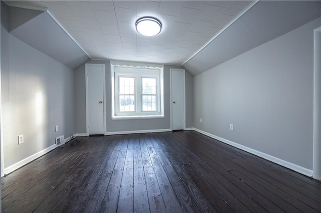 bonus room with lofted ceiling and dark wood-type flooring