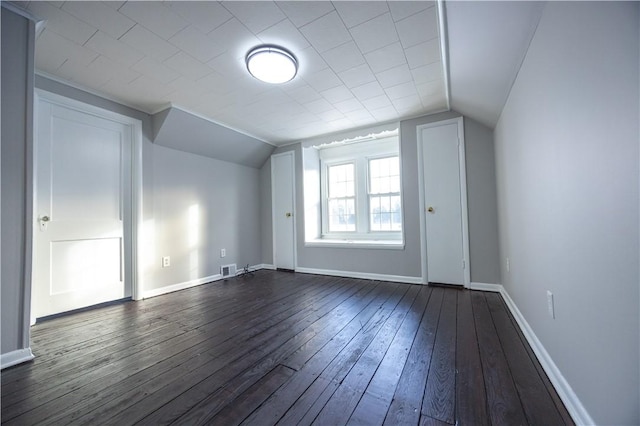 bonus room featuring vaulted ceiling and dark hardwood / wood-style floors