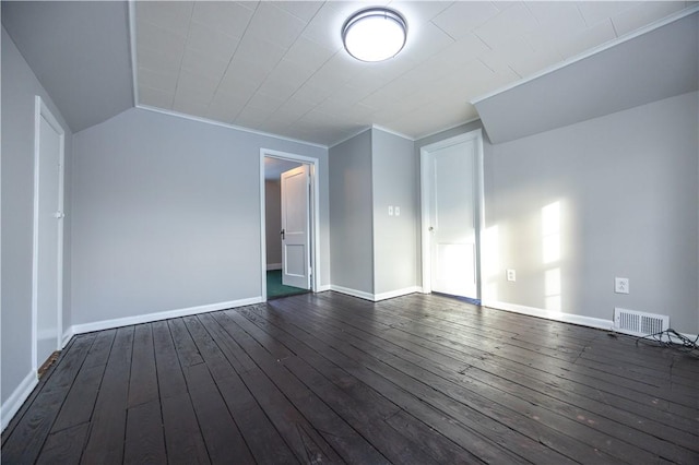 spare room featuring ornamental molding and dark wood-type flooring