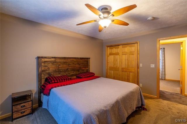 carpeted bedroom with ceiling fan, a closet, and a textured ceiling