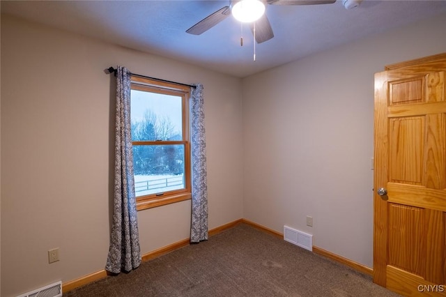 empty room featuring dark colored carpet and ceiling fan