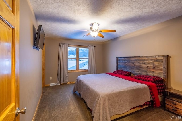 carpeted bedroom featuring a textured ceiling and ceiling fan