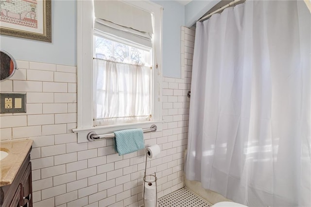 bathroom with tile patterned flooring, vanity, and tile walls